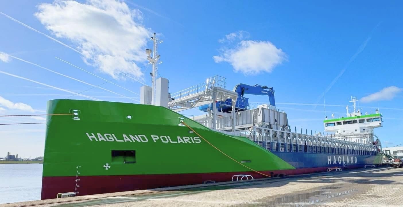 Hagland Polaris 4,800 DWT hybrid trader docked at Royal Bodewes Hoogezand, green and blue hull with white bow lettering.